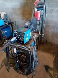 Miller XMT 350 Welder & Miller 22A 24V Wire Feeder, CC/CV DC Inverter, Welding Lead, Ground, Mig Gun, Reef, Flow Gauge On Cart. S/N# LG050258A.