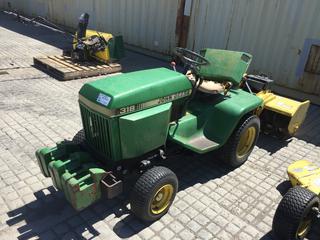 John Deere 318 Tractor c/w Gas Power, 3 Point Hitch Rototiller, 16x6.5-8 Front, 23x10.5-12 Rear Tires. S/N M00318X228965 Showing 799 Hours.