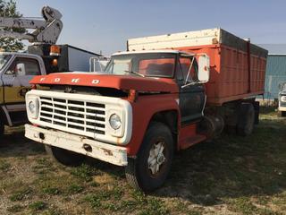 Selling Off-Site - 527 North 200 East, Raymond, AB -  1974 Ford 700 Grain Truck c/w  Box & Hoist. Showing 71,586 Mi. S/N F75FV09594. Note: No Keys, Running Condition Unknown.
