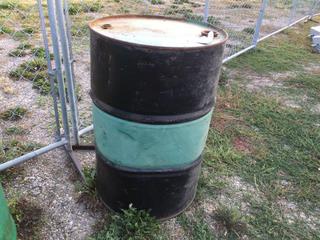 Selling Off-Site - 527 North 200 East, Raymond, AB -  Green/Black 45 Gal. Drum.