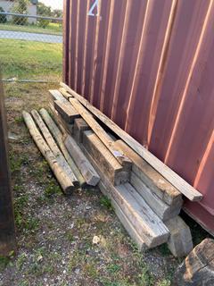Selling Off-Site - 527 North 200 East, Raymond, AB -  Pile of Assorted Wood Posts.