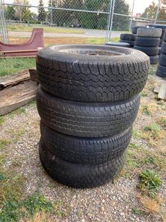 Selling Off-Site - 527 North 200 East, Raymond, AB -  (4) 14" Oldsmobile Rims & Tires.