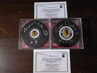 Bobby Hull and Pierre Pilote Signed Chicago Blackhawks Pucks.  C.O.A. From Frozen Pond.  Inscribed "#9 and "H.O.F. 75"