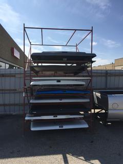 Metal Rack With Assorted Tonneau Covers.