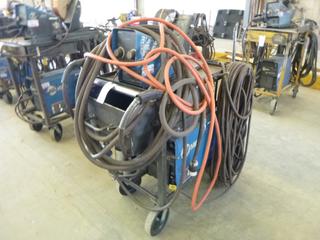 Miller XMT 350 Phase 1 and 3 Welder S/N MB030864A w/ Cart and Wire Feeder. 