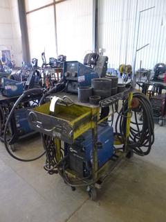 Miller XMT 350 Phase 1 and 3 Welder S/N LG230007A w/ Contents, Cables, Cart, and Wire Feeder. 