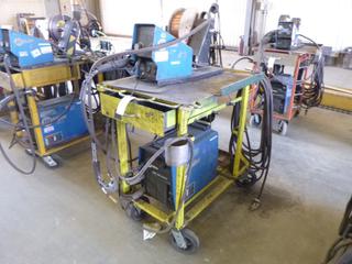 Miller XMT 350 Phase 1 and 3 Welder S/N MB060012A w/ Contents, Cables, Cart and Wire Feeder. 