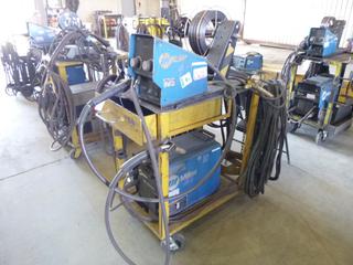 Miller XMT 350 Phase 1 and 3 Welder S/N LG120479A w/ Contents, Cables, Cart and Wire Feeder. 