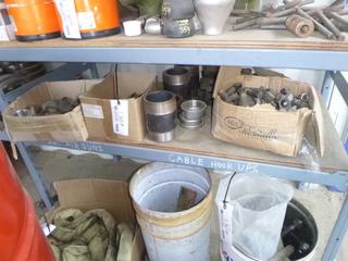 Shelf of Bolts, Fittings, Elbows, and Gaskets. 