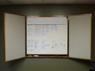 White Board w/ Retractable Projector Screen. 