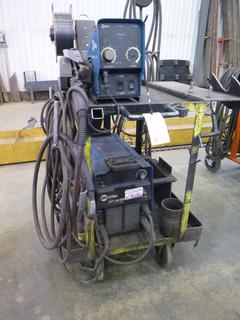 Miller Phase 1 and 3 XMT 304 Inverter Arc Welder S/N LE121423 w/ Cart and Wire Feeder. 