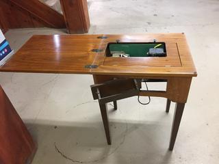 Sewing Machine Station In Wooden Table.