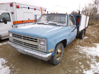 1983 GMC 3500 High Sierra Dually c/w 5.7L, A/T, Showing 170,554 Kms, GVWR 4,900 LB, LT 235/85R16 Tires At 60%, Front and Rear Axle Rating 2,684 LB, Flatbed With Plywood Sides, VIN 2GTCC14D1D1522332 *Note: Damage To Passenger Fender, Rust* (E. Fence)