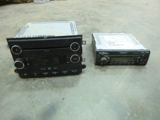 (1) Ford Radio/CD Player, Model BC3T-18C869EG, (1) Kenworth Radio / CD Player, Part Q-28-6017-013 (B2)