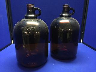 (2) 160oz Brown Glass Jugs.