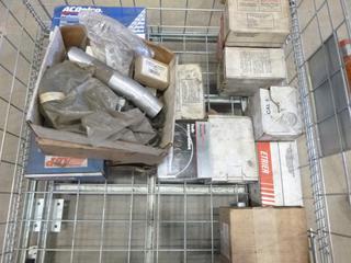 Crate of Assorted Auto Parts Including Starters, Oil Filters, Mufflers, Fuel Filters, Air Hose and More (K-1-1)