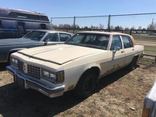 Selling Off-Site -  1979 Oldsmobile Regency  Ninety-Eight Car c/w V8, Auto, With Key, Showing 70,236 Kms, VIN 3X69RAM167183. Location - 527 North 200 East, Raymond, AB -  For Further Information Please Call Chris 403-308-1161.
