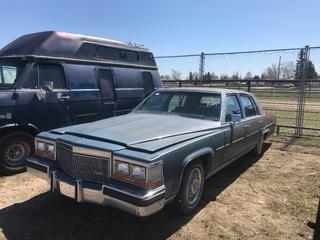Selling Off-Site -  1986 Cadillac Fleetwood Car c/w V8, Auto, With Key, Showing 84,304 Kms, VIN 1G6DW69Y8G9734356. Location - 527 North 200 East, Raymond, AB -  For Further Information Please Call Chris 403-308-1161.
