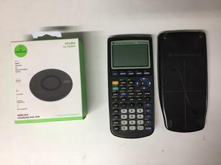 Texas Instruments T1-83 Plus Calculator & Belkin Charging Pad.