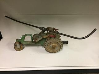 Metal Tractor Sprinkler w/Movable Wheels. Approximately 20".