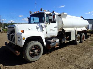 1986 Ford LT9000 Water Truck C/w Cummins Diesel Engine, 8-Spd RoadRanger Transmission, T/A, Spring Over Walking Beam Suspension, 19ft X 8ft X 5ft Tank, Front Axle Rating 12,000 lbs, Rear Axles Rating 38,000lbs, 50,000lbs GVWR. Showing 369,009kms, 7946hrs. VIN 1FDYU90L3GVA03523 *Note: Passenger Door Dented Won't Shut Properly Requires Repair*