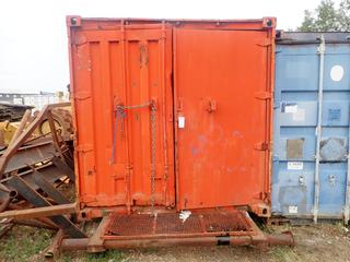 20ft Skid Mtd. Storage Container C/w Wood Shelving, Unused CAT Filters, CAT Parts, Air Hose And Misc Supplies *Note: Hole Inside Of Storage Container, Damaged, Doors Require Repair, Buyer Responsible For Load Out*