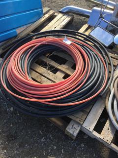 Partial Roll of Orange 1/2" Water Hose & Partial Roll of 1" Black Water Pipe.