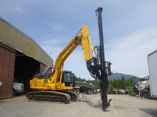 2012 Komatsu PC200LC-8 Excavator C/w 2013 John Henry JH20 Excavator Mounted Drill System, 20ft Drill, Rear Mount Compressor, Cat C4.4  Drive Motor, Hydraulic System And Controls, 31.5in Triple Grouser Pads, Light Package And Icom Radio. Showing 3368hrs. SN A90808, PIN KMTPC180L54A90808