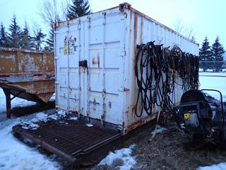 20ft Skid Mtd. Storage Container C/w 26ft Skid, Side Hangers, 240V Plugins, Lights And Wood Shelving *Note: Contents Inside And On Side Side Included, Buyer Responsible For Loadout, Item Cannot Be Removed Until Wednesday December 15th Unless Mutually Agreed Upon*