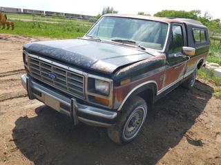 1986 Ford F-150 Lariat XLT Single Cab Pickup c/w A/T, A/C, P235/75R15 Tires, 8 Ft. Box w/ Canopy, Showing 179,251 Kms, VIN 2FTCF15N5GCA92702 *Note: No Engine*