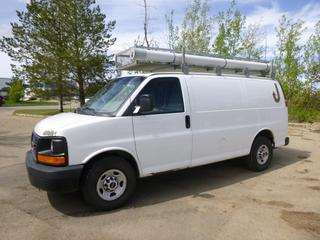 2012 GMC Savana 2500 Cargo Van, C/w 4.8L V8, Gas, A/C, Roof Rack w/ Storage Cage 12 Ft. 1 In. x 3 Ft. and Storage Tube, Wood Bed Liner In Cargo Area w/ Storage Shelf, Ladder to Roof Mounted on Rear Door, Tire Size 245/75/R16, Axle Rating 4100 Lbs Front, 5360 Lbs Rears,  Showing 277,074 Kms, 4543 Hours, VIN 1GTW7FCA3C1116692 *Note:  Windshield Cracked, Body Rust*