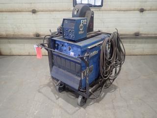 2010 Miller Dimension 302 230/460/575V 3-Phase CC/CV.DC Welding Power Source, SN MA260461U C/w Cable And Miller Model S-64 24V Wire Feeder, SN KH444907. *Note: Working Condition Unknown, Wire Feeder Requires Repair As Per Owner*