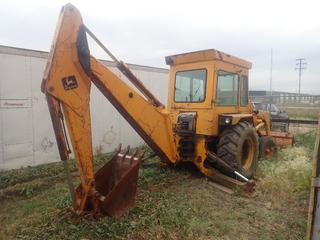 1977 John Deere JD410 Loader Backhoe C/w John Deere 4219DT03 Diesel Engine, 22in Dig Bucket, 88in Cleanup Bucket, 8-Spd Manual Transmission, LT265/75 R16 Front Tires And 18.4-26 Rear Tires. Showing 2290hrs. SN 027632T *Note: Runs, Needs New Battery, Transmission Leak, Engine Rebuilt, Buyer Responsible For Loadout, This Item Is Located @ 6614 50Ave Lloydminster, For More Information Contact Tony @780-935-2619*