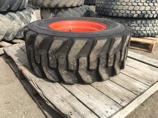 (1) Bobcat Bear Guard Tire 12-16.5 NHS w/ Rim.