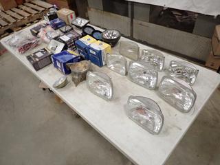 (4) Kenworth Spotlights 4GE-H6054 Headlights, (4) Round Spotlights, (4) Spotlight Covers, (2) Backup Lights c/w Box Of Spotlights And Assorted Supplies (J-2-1) 