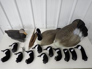 (12) Red Head Canada Goose Flocked Decoys and (1) Duck Decoy. (9-D-2)