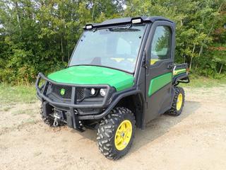 2022 John Deere Gator 4X4 Utility Vehicle c/w John Deere 12-Valve Inline 3 Gas Engine, AC/Heater, 52 In. X 44 In. X 12 In. Hydraulic Tilt Box, Warn 4500lb Winch And 27X9.00R14 Tires. Showing 155.7hrs, 814 Miles. VIN 1M0835MDVNM050942