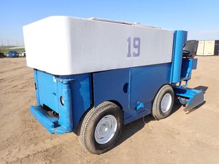 Zamboni c/w Inline 4 Gas Engine, Hydrostatic Transmission And 7.00-15LT Tires. Showing 1905hrs *Note: Has Hydraulic Leak When Using Auger, Cracks Around Wheel Wells On Tires, Hoses Torn And Dry Rot*