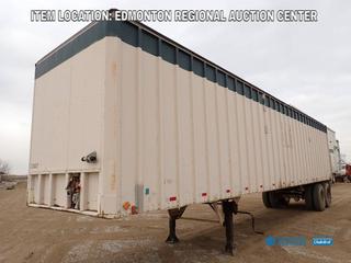 Fort Saskatchewan Location - Grindy 43 Ft. X 8 Ft. 6 In. T/A Storage Van Trailer c/w Shelving Unit, Contents, Spring Susp, 10.00-22 Front Tires And 11R24.5 Rear Tires. VIN 97718E *Note: Rust And Dents On Body*