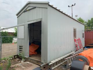 Metal Skid Mounted Outbuilding c/w Power/Lights, Forced Air Furnace, Located Offsite, Call Mario For Details 403-200-5827 *Note: Buyer Responsible For Loadout*(LOCATED IN CALGARY)