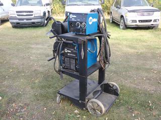 Miller XMT 350 208/230/400/460/575V 1/3-Phase Multi-Process Welder, SN LG290054A c/w Miller 22A 24V Wire Feeder, Reels, Cable And 25in X 31in X 42in Cart  **Located In Edmonton**
