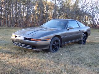 1989 Toyota Supra 2-Door Targa Top Coupe c/w Toyota 3000 Twin Cam 24-Valve Intercooler Turbo 7M-GTE Engine, A/T, Adjustable Coil Over Suspension And 255/50R16 Tires. Showing 320,320kms. VIN JT2MA71J2K0131201 *Note: Project Car, Windshield Cracked* **Located In Edmonton**
