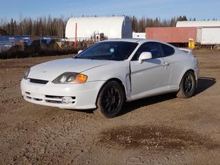 2003 Hyundai Tiburon SE 2-Door Sedan c/w 2.0L, A/T, Power Sunroof And 215/50R17 Tires. Showing 270,906kms. VIN KMHHN65D53U021504 *Note: Dent In Driver Side Front Fender, Driver Door Does Not Fully Open, Minor Rust Spots* **Located In Fort McMurray**