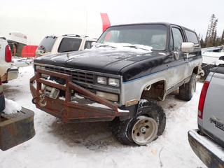 1990 Chevrolet Blazer 1500 4X4 SUV c/w 5.7L, A/T, Kodiak 12,000lb 12VDC Winch And 33X12.50R15LT Tires. Showing 271,675kms. VIN 1GNEV18KXLF167462 *Note: Dents, Tire Off Bead, Running Condition Unknown, Buyer Responsible For Removal* **Located In Fort McMurray** 