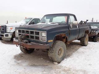 1984 GMC Custom-Deluxe20 4X4 Pickup c/w 5.7L, 3-Spd Manual, 8000lb 12VDC Winch And 35X12.50R15LT Tires. Showing 206,740kms. VIN 2GCGK24M2E1204862 *Note: Rust, Turns Over Does Not Start, Running Condition Unknown* **Located In Fort McMurray**