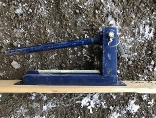 Crimper Mounted To Wooden Plank.