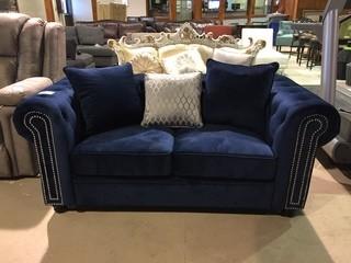 Navy Velvet Tufted Two Seater Sofa with Matching Pillows.