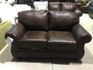 Benchcraft Leather-Look Upholstered Loveseat with (2) Throw Pillows.