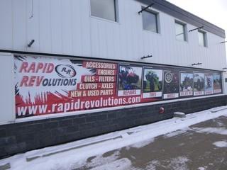 (2) Vinyl Banners, Independent 284" x 52", Rapid Revolutions 504" x 64" *NOTE: Buyer Responsible For Removal, Tools Needed, Screwed To Wall*  Images on large Banner are Approx 3ft by 4ft.