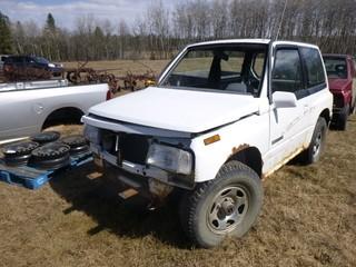 1991 Chevrolet Tracker Jeep C/w A/T. Showing 310,911kms. VIN 2CNBJ18U8M6924228. *Note: Parts Only, Missing Seats, Engine, Windshield And Front Bumper*